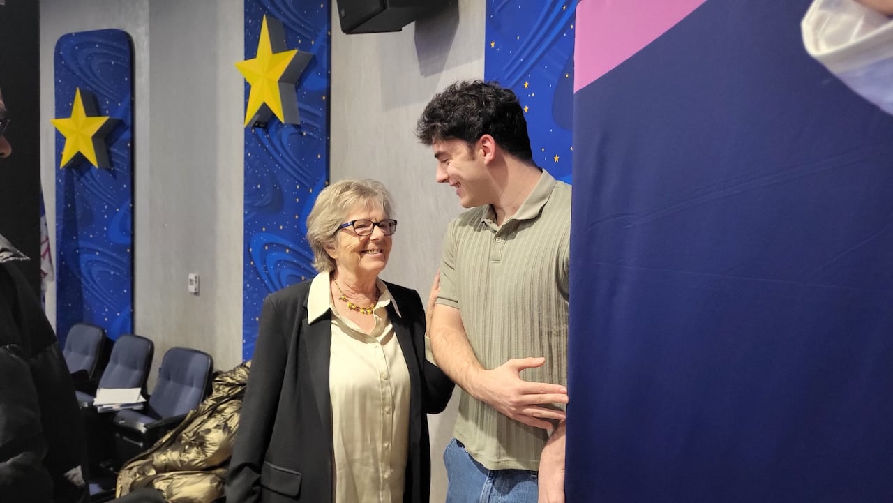 Two people smiling at each other .