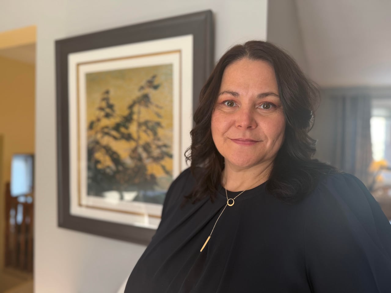a woman standing in her living room. 