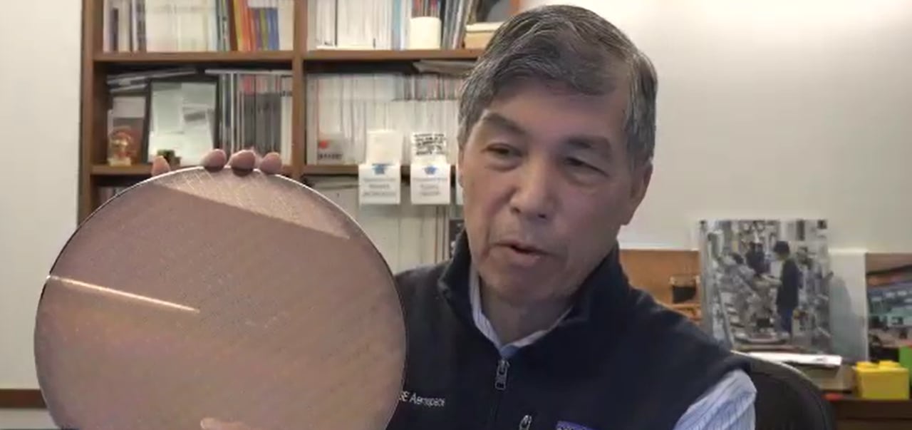 Willy Shih, a professor in the Technology and Operations Management unit at the Harvard Business School, holds up a wafer, a foundation for memory chips.