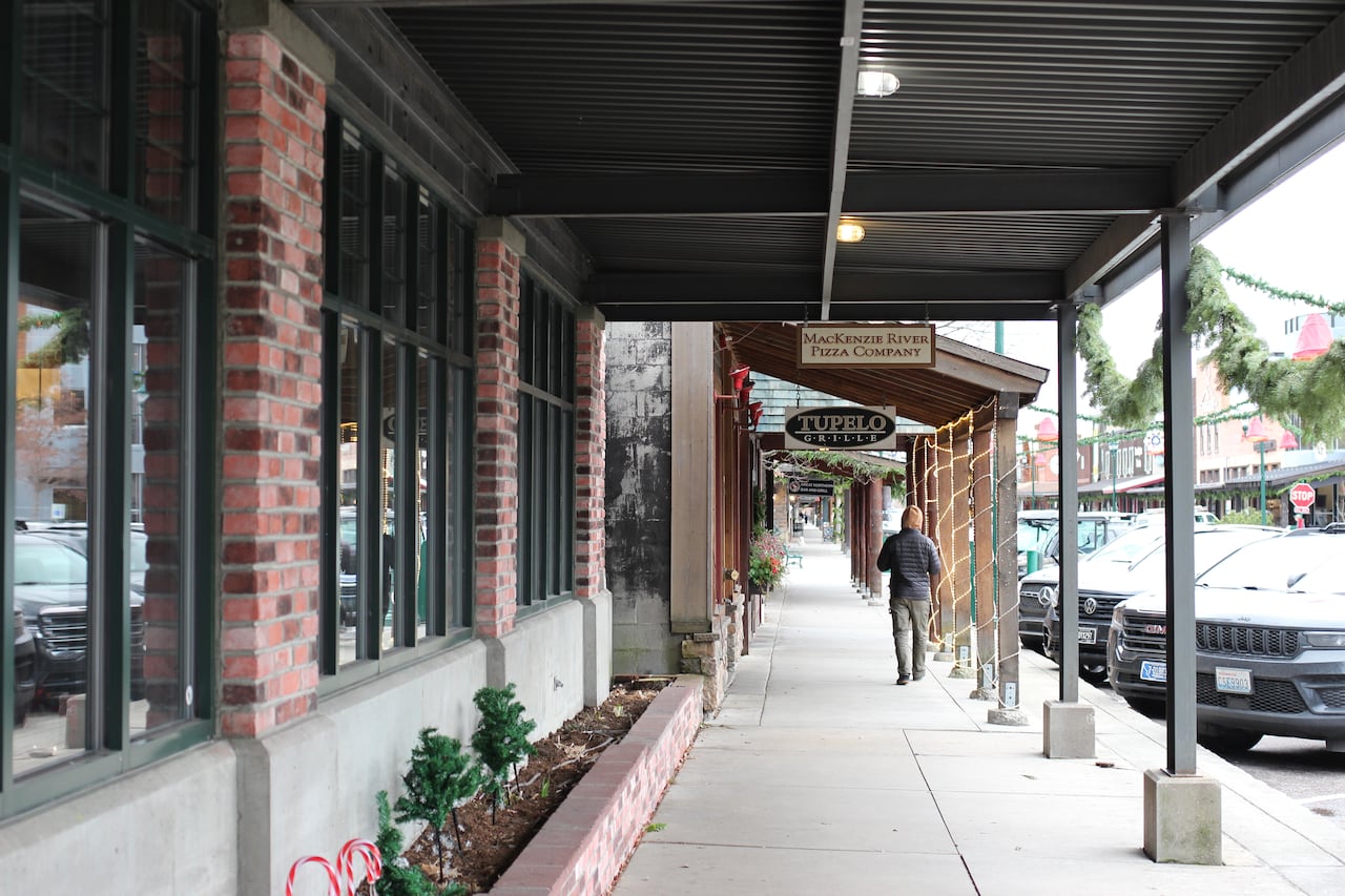 A man is pictured walking through downtown Whitefish, MT.
