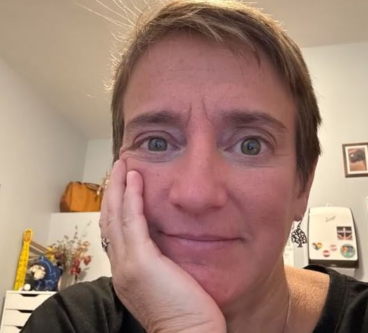 Close-up of woman with hand on her face.