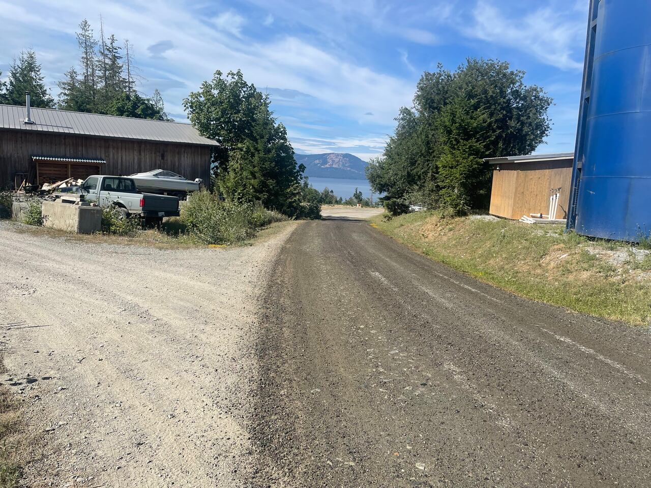 A dirt road, one side dry, one side wet after having the solution applied to it 