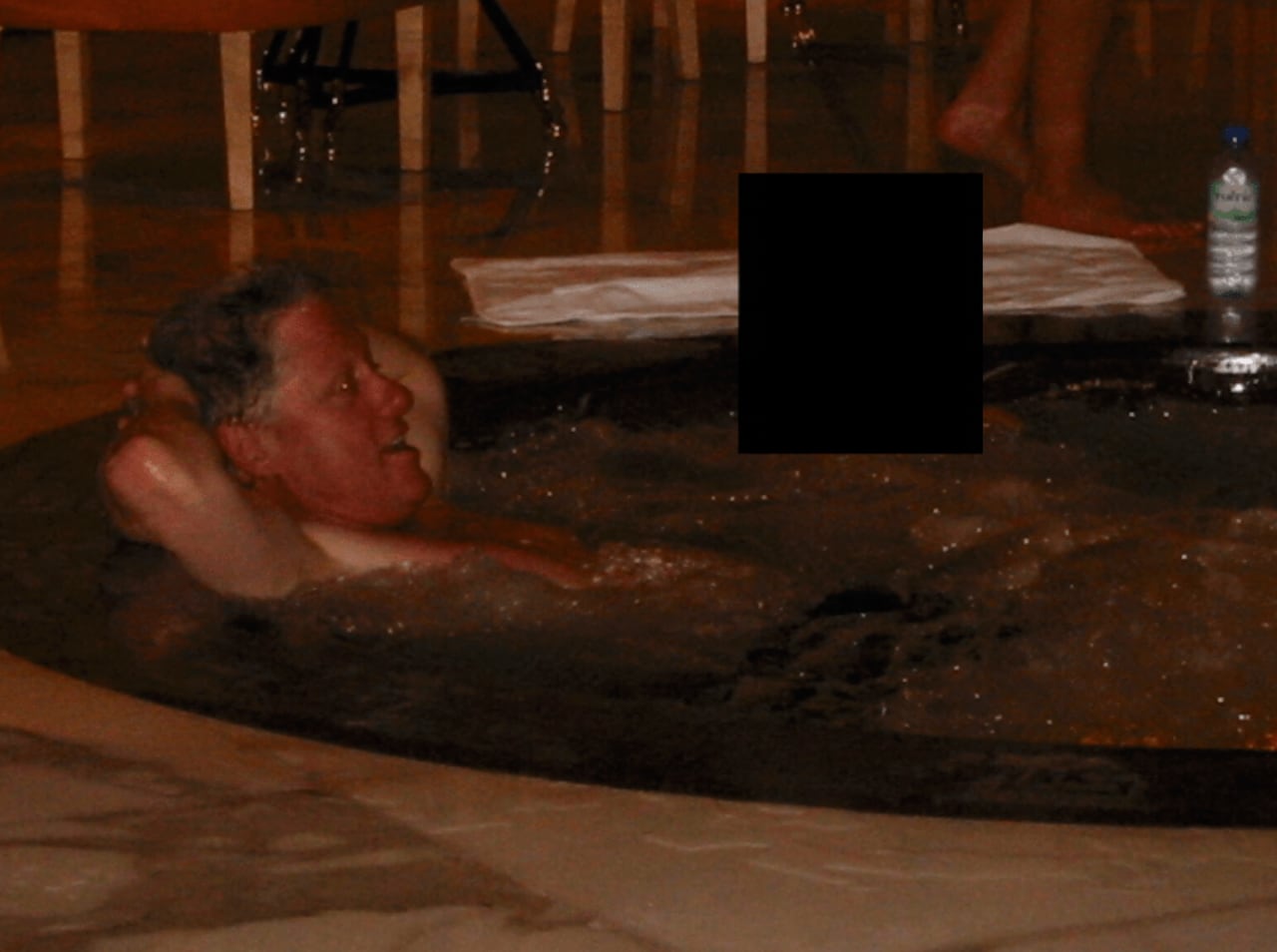 A grey-haired man is pictured in a hot tub.