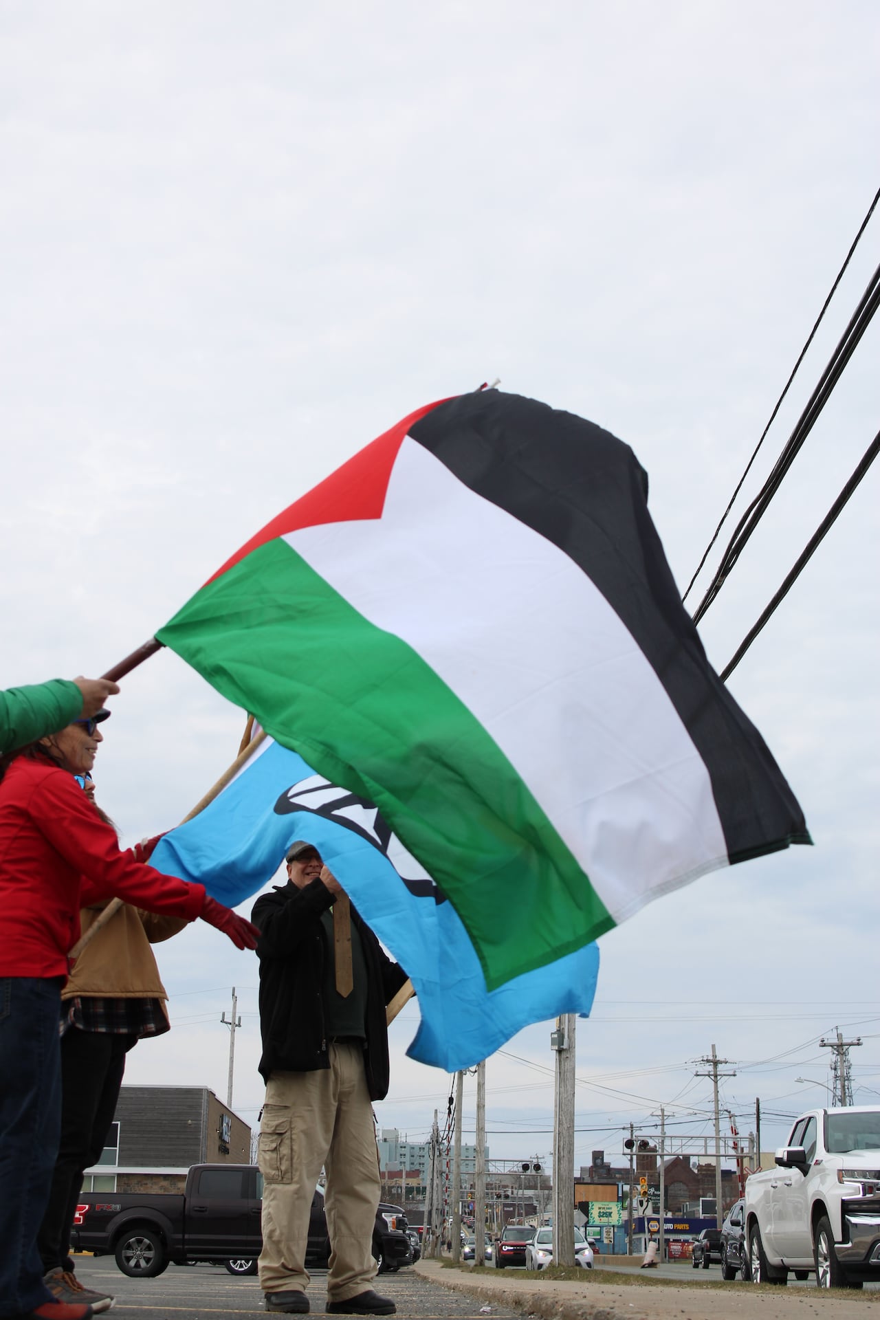 Two people waving large flags
