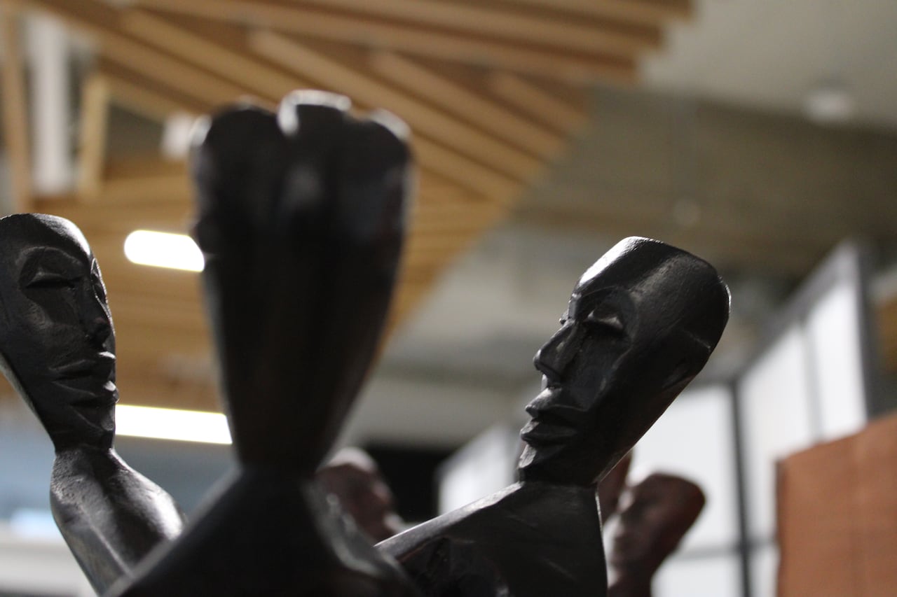 up close image of a carved sculpture with faces joined in a circle