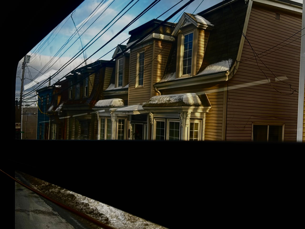 colorful houses in a row seen from a bus window