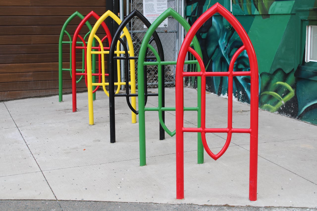 red, green, black and yellow metal bike rack
