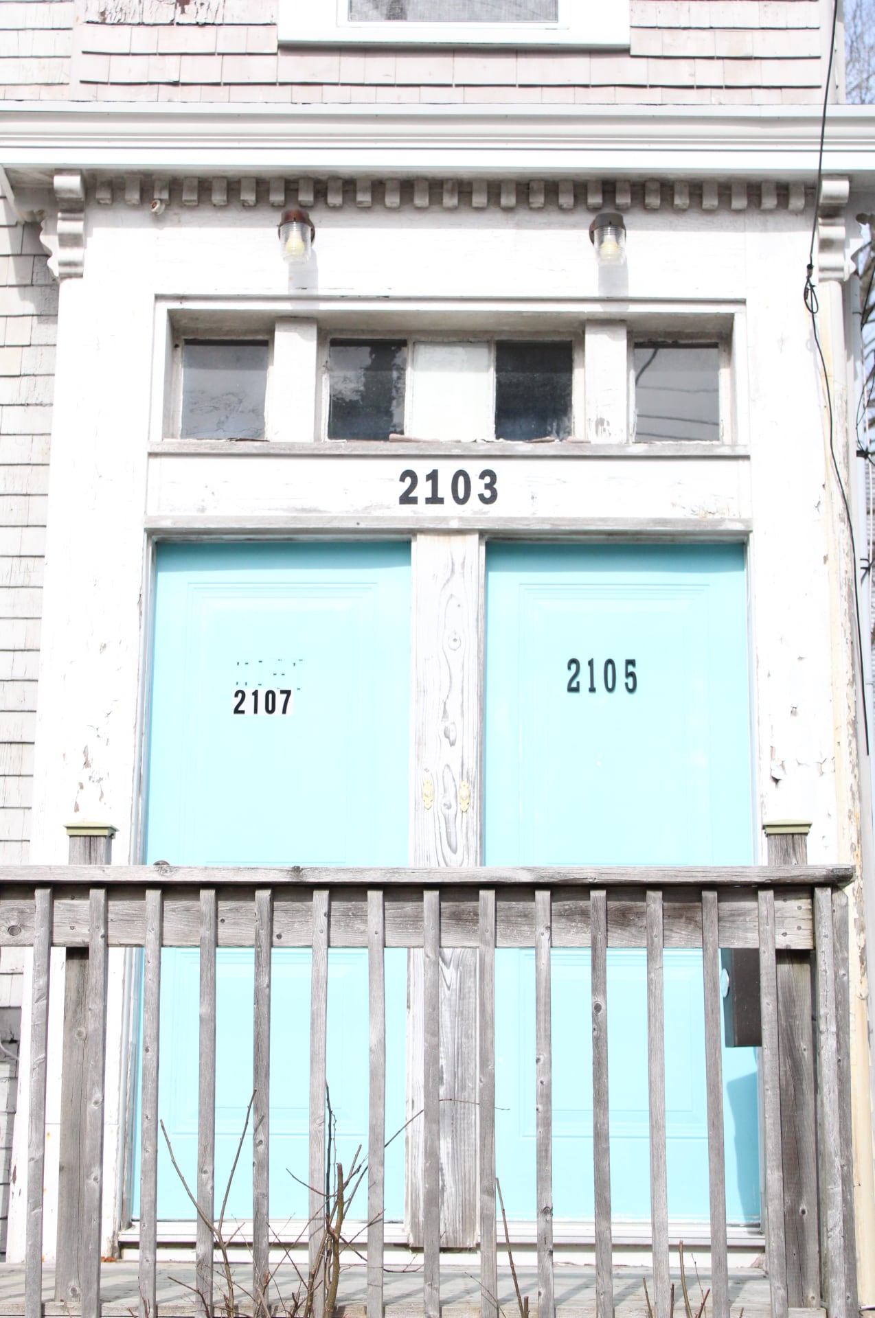 two teal blue doors of an apartment