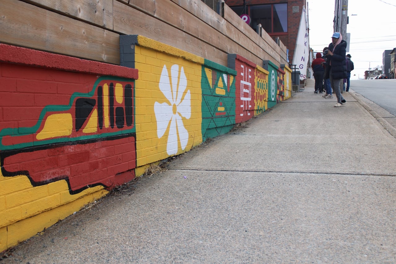 A colorful mural of red, yellow, black and green designs