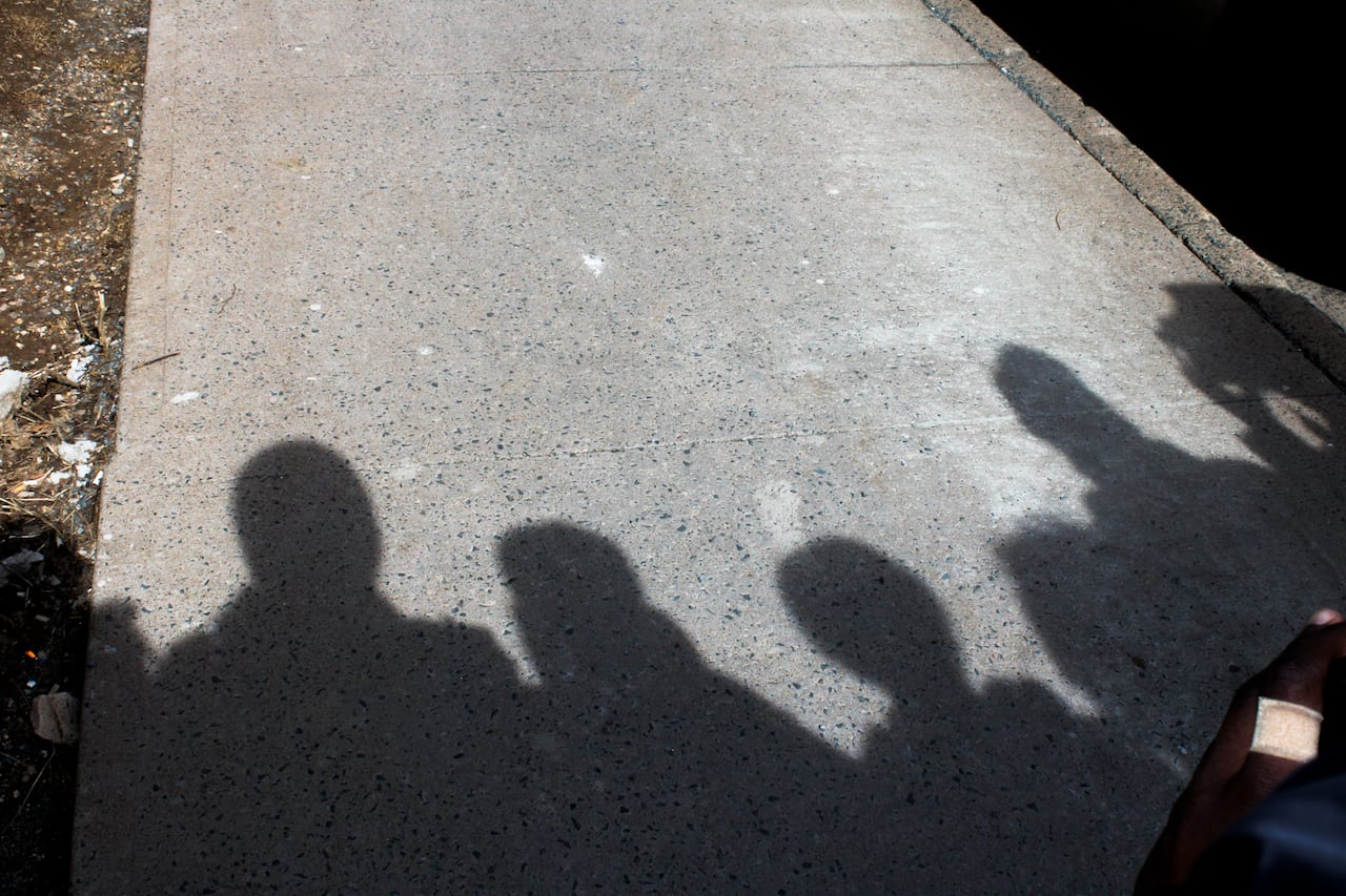 people's head shadows on a sidewalk
