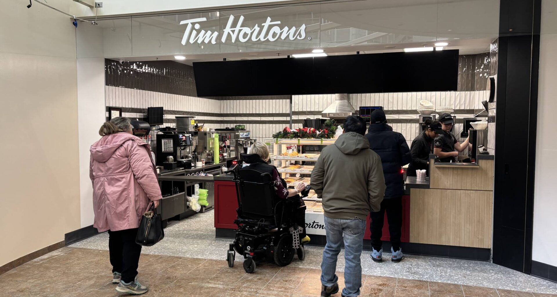 Customers wait in line at the Tim Hortons in the Brandon Regional Health Centre on Monday afternoon. (Tessa Adamski/The Brandon Sun)
