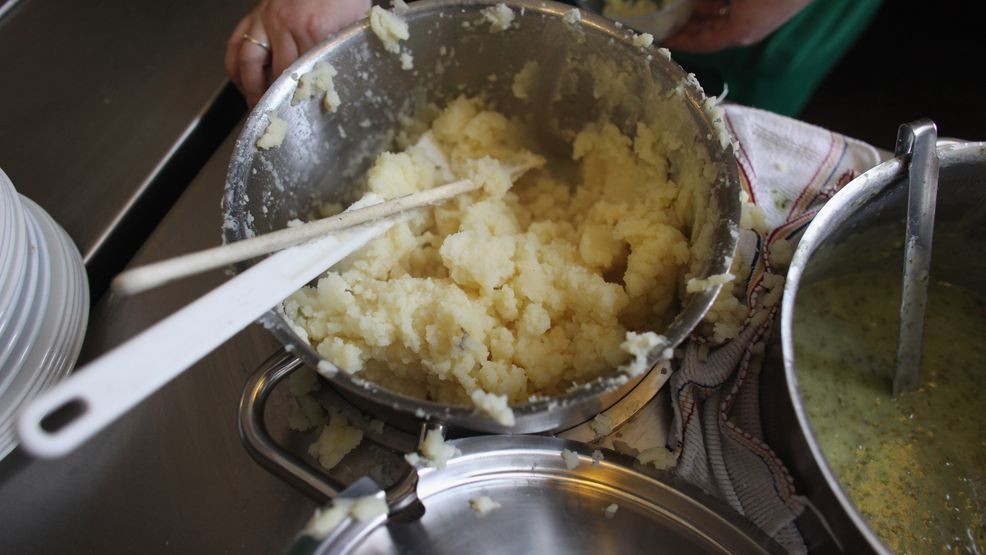 FILE - A staff member serves mashed potatoes on February 25, 2011 in London, England. (Photo by Oli Scarff/Getty Images)