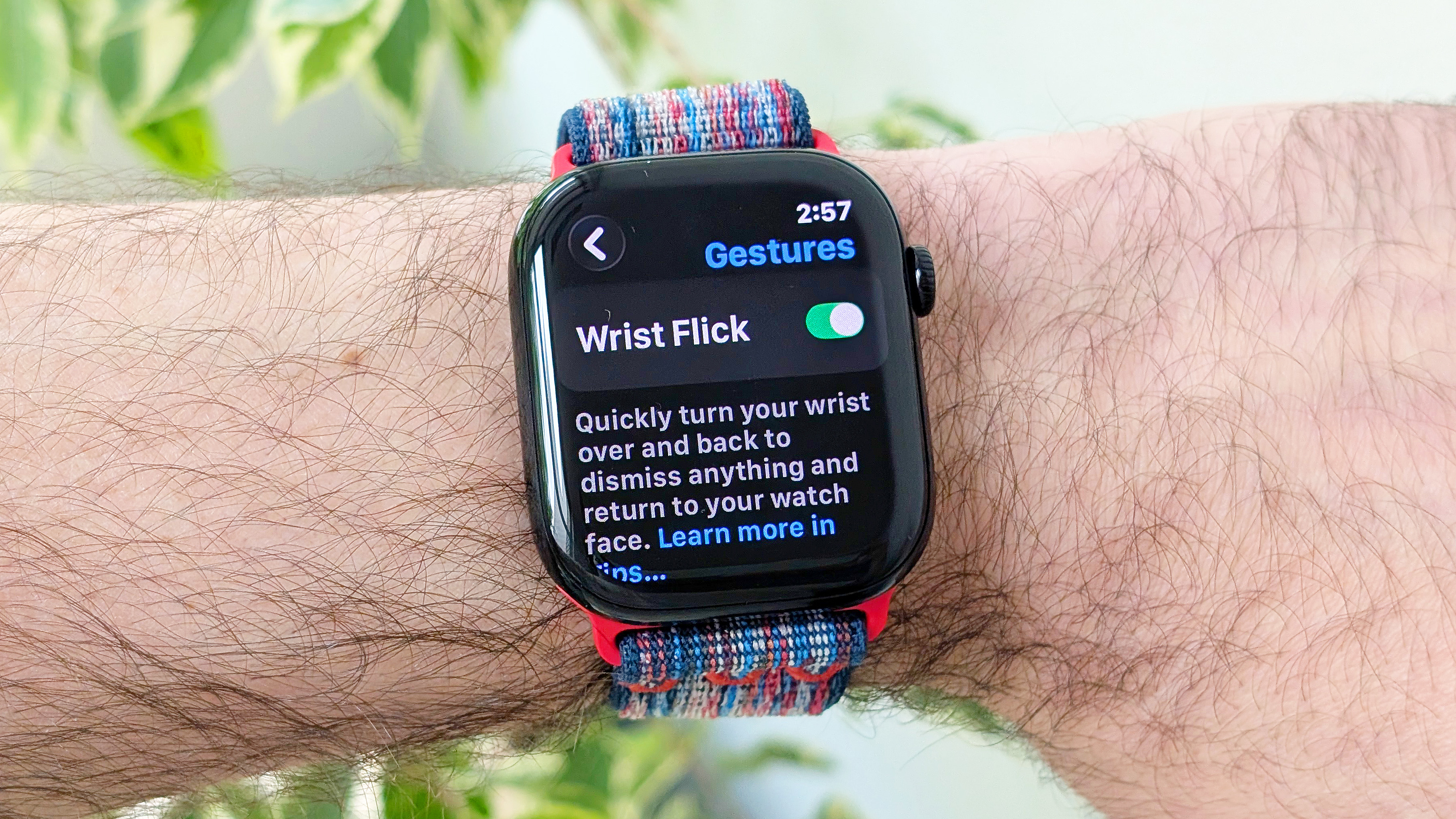 Close-up of the Apple Watch Series 10 on a user's wrist showing the new wrist flick gesture used to dismiss notifications hands free