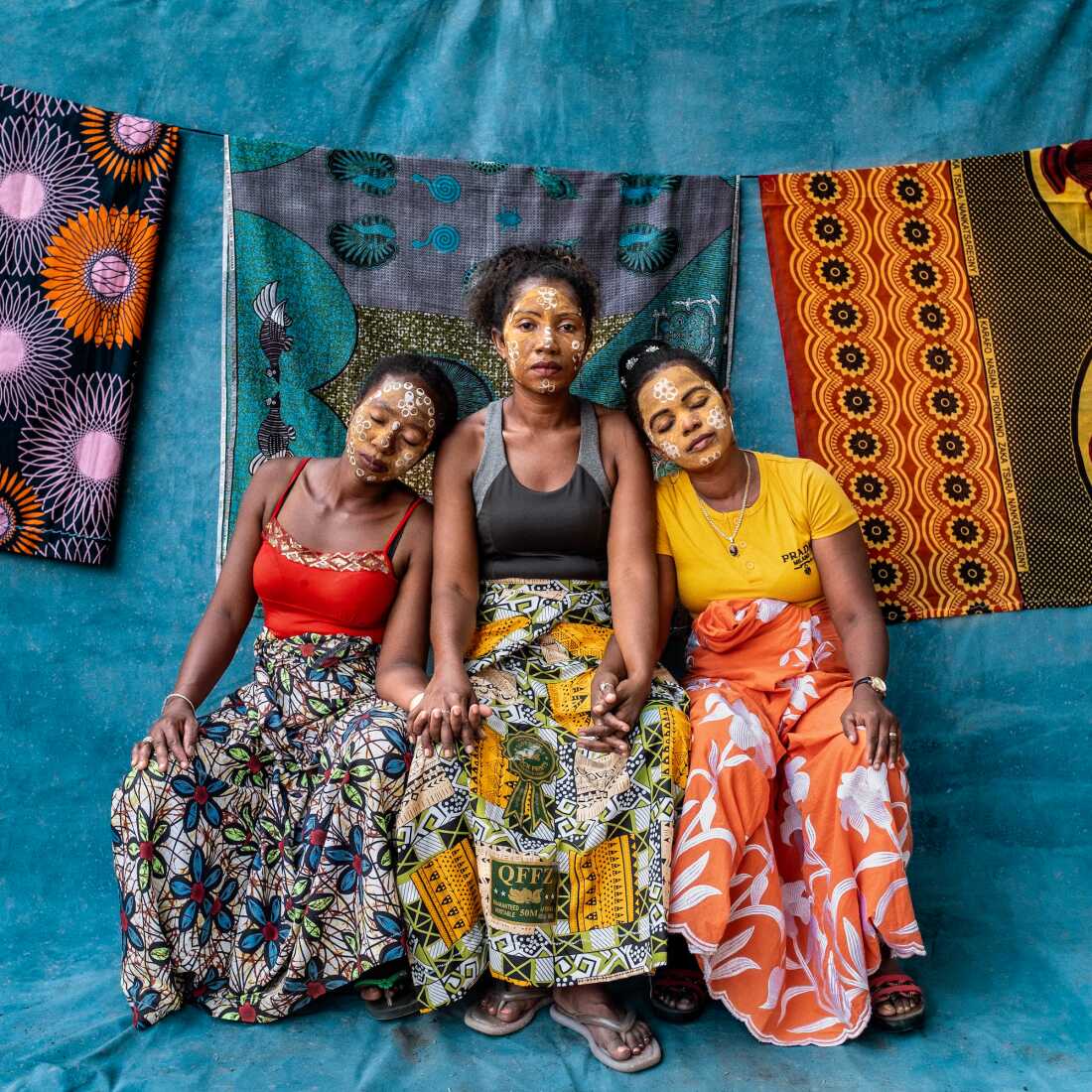 The photo exhibit Sahy Rano, on display at the Photoville Festival in Brooklyn, New York, through this weekend, draws its title from a Malagasay phrase translated in a wall label as meaning "someone who is not afraid to dive into the water, even if there is a strong current." The photographer wants to bring attention to female genital schistosomiasis, a neglected tropical disease caused by a waterborne parasitic infection, whose symptoms can be stigmatizing because they resemble symptoms of sexually transmitted diseases. From left to right: former patients Rahama Abdallah, Sylvia Razanaparana and Suzanie Yolandrie. They were photographed in September 2024 in the district of Ambanja in Northern Madagascar.