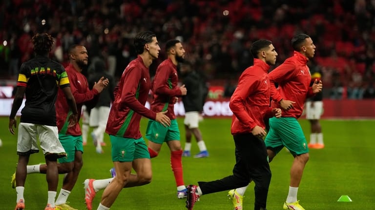 Morocco's Achraf Hakimi second from right, with teammates warm up...