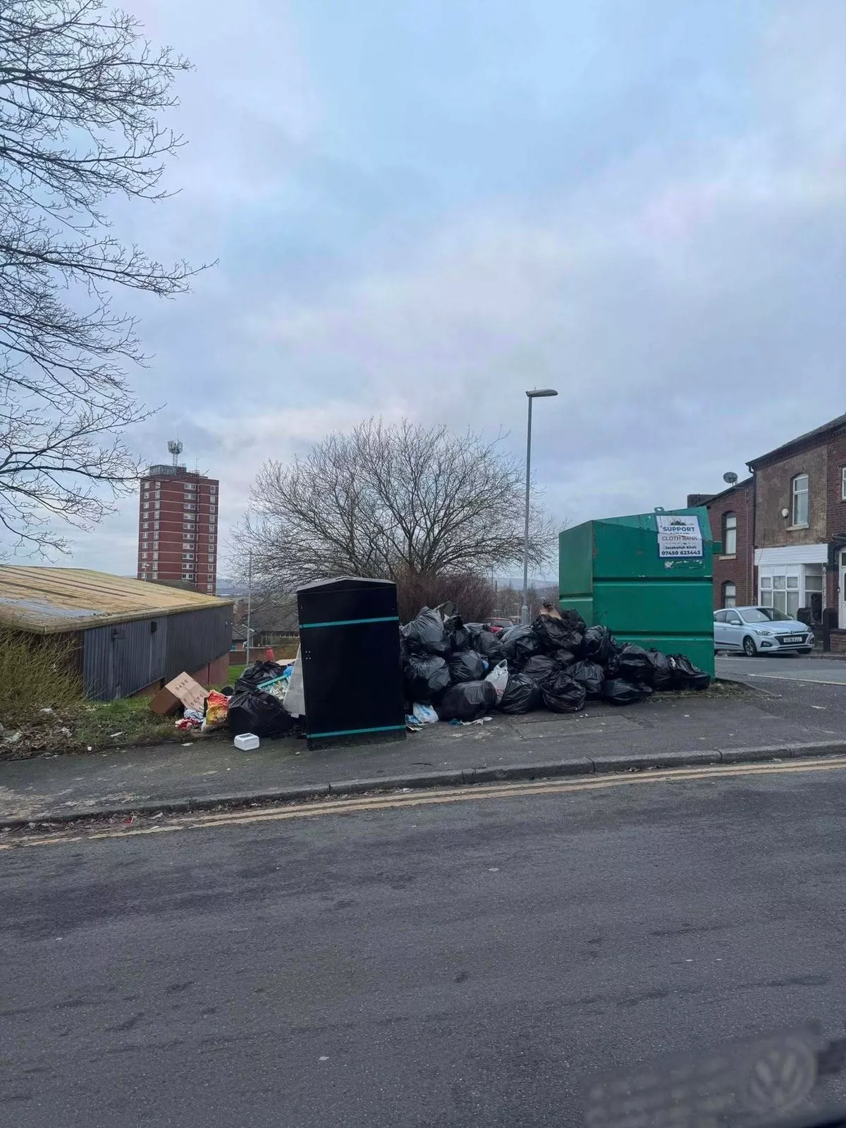 A photo by a local resident shows the area next to the bin piled high with household rubbish bags. 