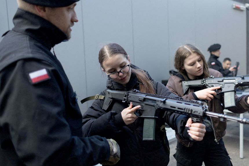 A group of civilians takes part in training military techniques in a session billed as 