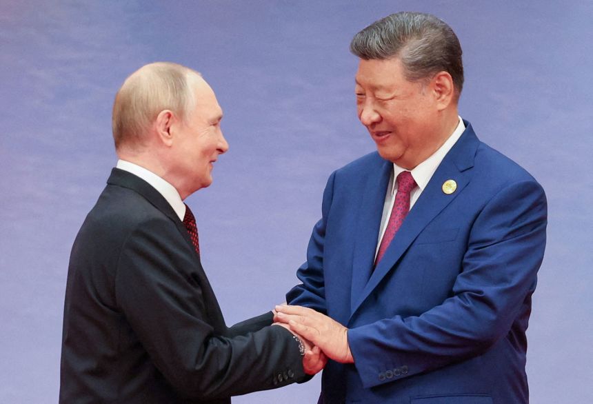 Chinese President Xi Jinping welcomes Russian President Vladimir Putin during a ceremony at the Shanghai Cooperation Organisation summit in Tianjin, China, on  August 31.