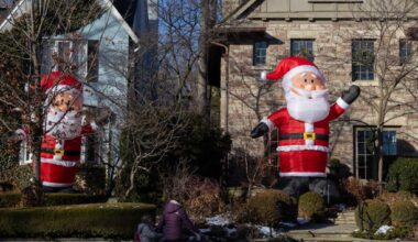 Giant-sized inflatable Santa Clauses seen on street in Toronto, Canada-Xinhua