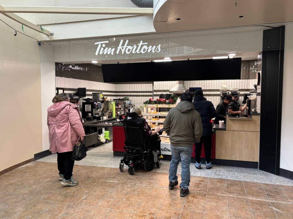 Customers wait in line at the Tim Hortons in the Brandon Regional Health Centre on Monday afternoon. (Tessa Adamski/The Brandon Sun)