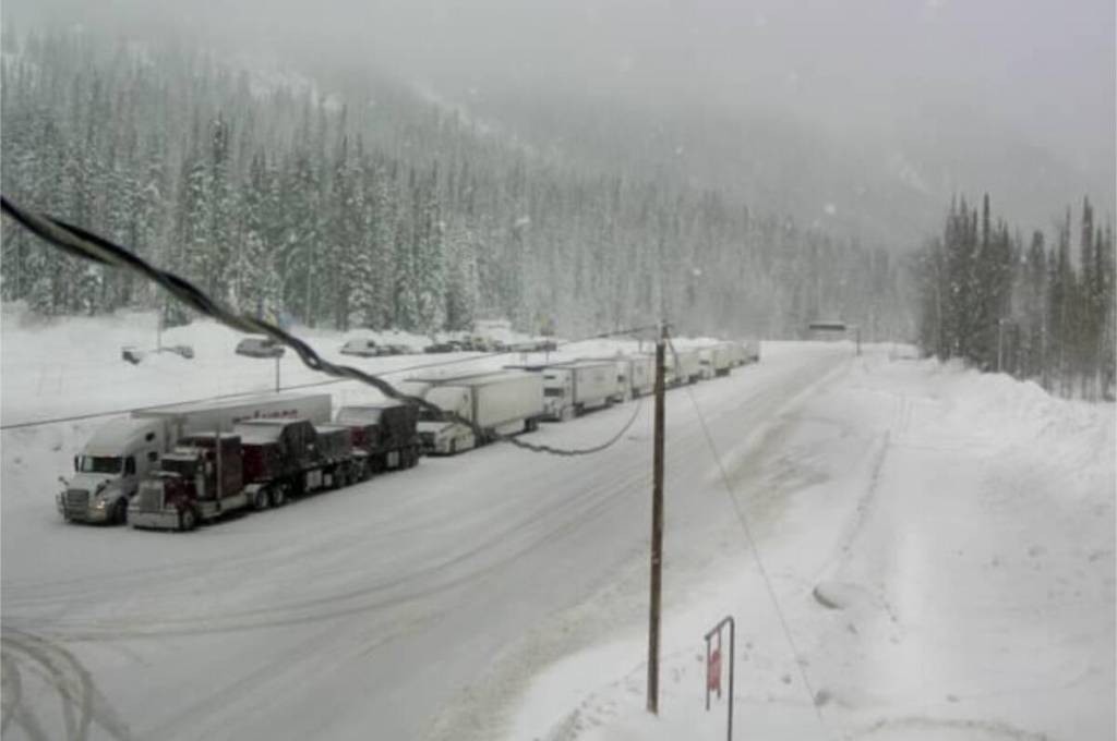 Semi tractor-trailers lined up waiting westbound at Rogers Pass following a motor vehicle fatality on the Trans-Canada Highway near Revelstoke on Friday morning, Dec. 12. (Photo courtesy DriveBC)