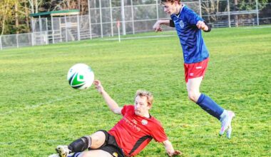 Parksvillians defender Jayson Matthews slides to kick the ball away from a charging Peninsula FC player. (Michael Briones photo)