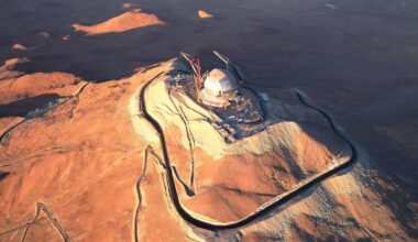 A drone shot showing a metal domed building against a desert peak in Chile