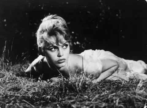 S.N. Pathe Cinema/Getty Images Brigitte Bardot lying in the grass in a still from the film The Bride is Much Too Beautiful from 1956.