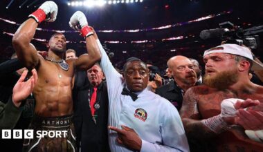 Anthony Joshua has his hand raised by the referee after beating Jake Paul by knockout in Miami