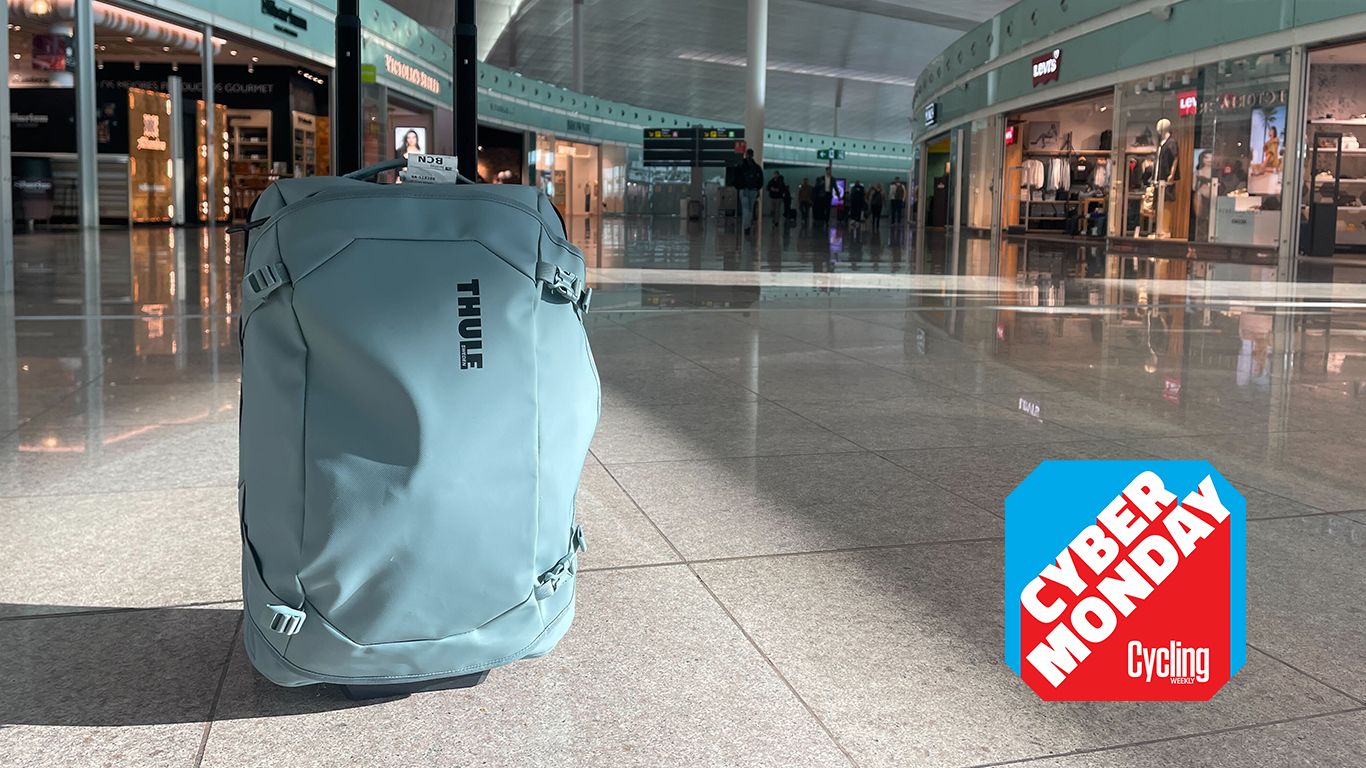 Thule wheeled carry-on in Barcelona airport in front of shops