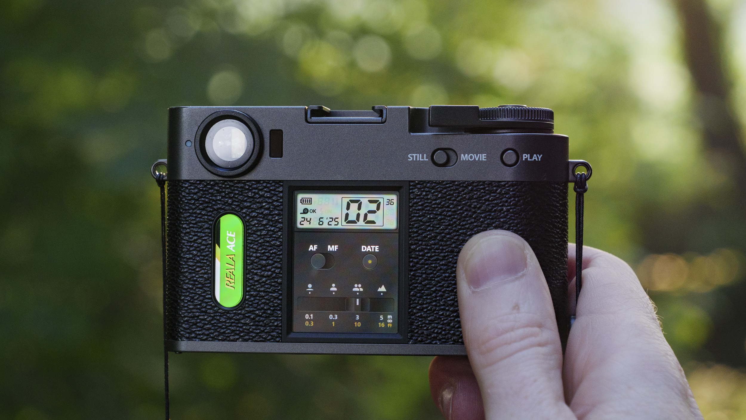 Fujifilm X half camera in the hand at golden hour