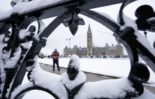 A worker prepares a pathway on Parliament Hill in Ottawa on Monday, Dec. 4, 2023. THE CANADIAN PRESS/Adrian Wyld