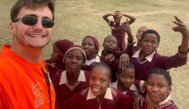 University of Leeds student Mitchell Hale stands with students involved with the cycling project in South Africa.