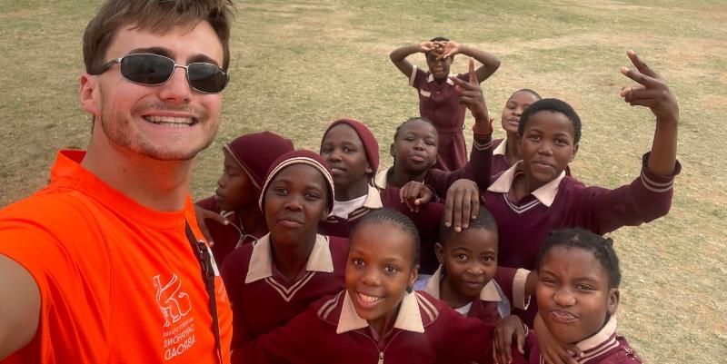 University of Leeds student Mitchell Hale stands with students involved with the cycling project in South Africa.