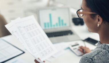 Businesswoman calculates finances in an office
