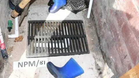 GMP A safe hidden in a brickhouse of the back garden at the home of Bilel Saadaoui, in Crankwood Road, Wigan, where cash was found after his arrest.