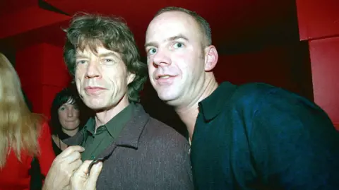 Getty Images Norman Cook and Mick Jagger, pictured together at a David Bowie after-party in London, 1999