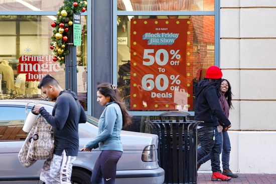 Shoppers browse for Black Friday deals at Atlantic Station outdoor mall, Friday, Nov. 28, 2025, in Atlanta, Ga. (AP Photo/Megan Varner)