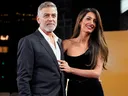 George Clooney and his wife Amal Clooney pose for photographers upon arrival at the screening of the film 