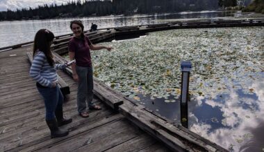 Jen Oden, Snohomish County Water Quality Specialist, and Megan Lane, LOCSS team member, report a lake height measurement at Flowing Lake, Snohomish County, Washington