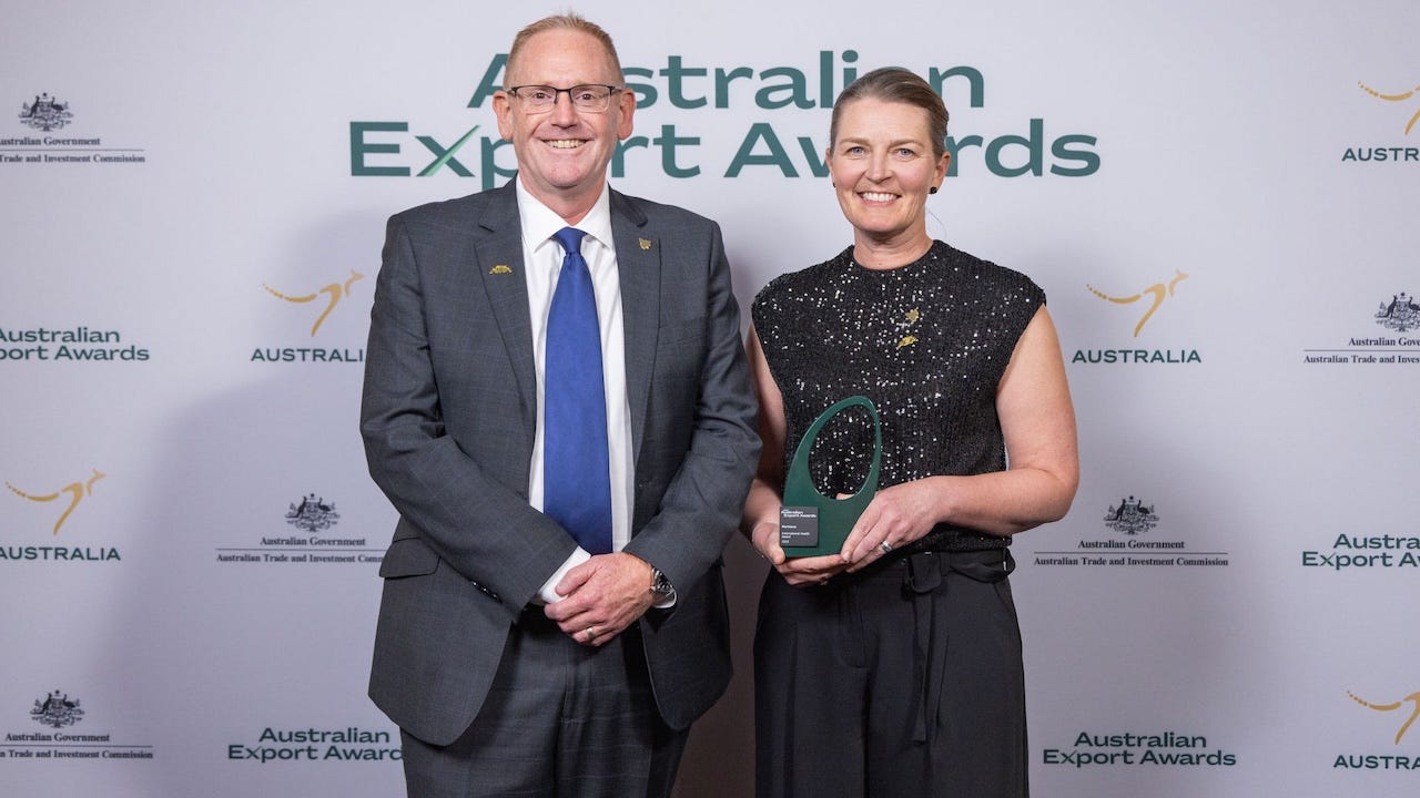 A man and woman accept an award at the Australian Export Awards A man and woman accept an award at the Australian Export Awards
