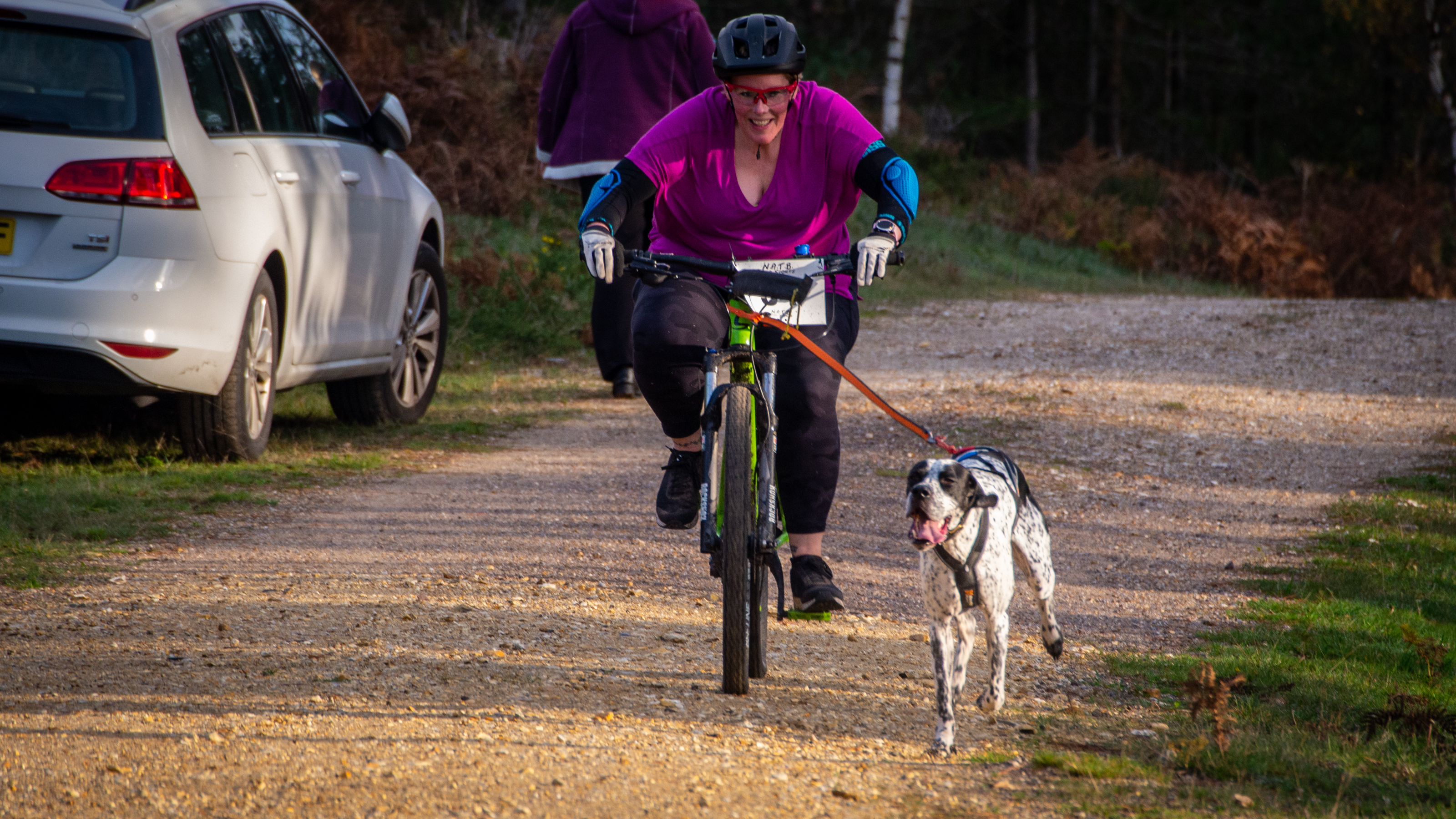 A woman and her dog bikejoring