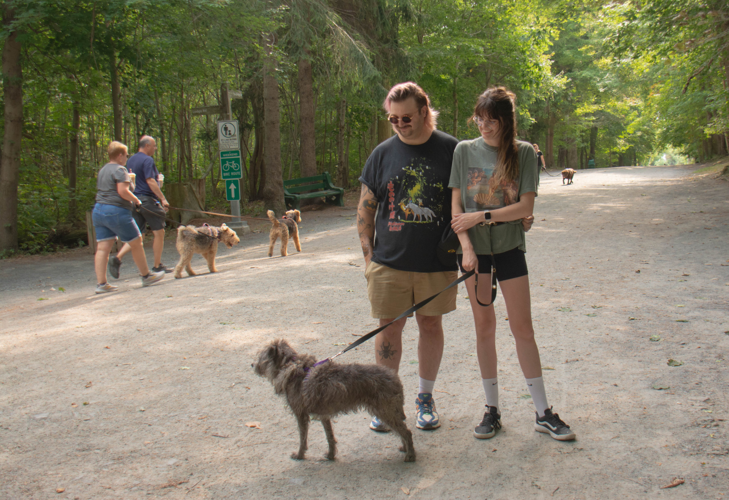Two people stand with their dog on a trail in Halifax's Point Pleasant Park, which recently reopened after weeks of closure due to the Nova Scotia government's woods ban.