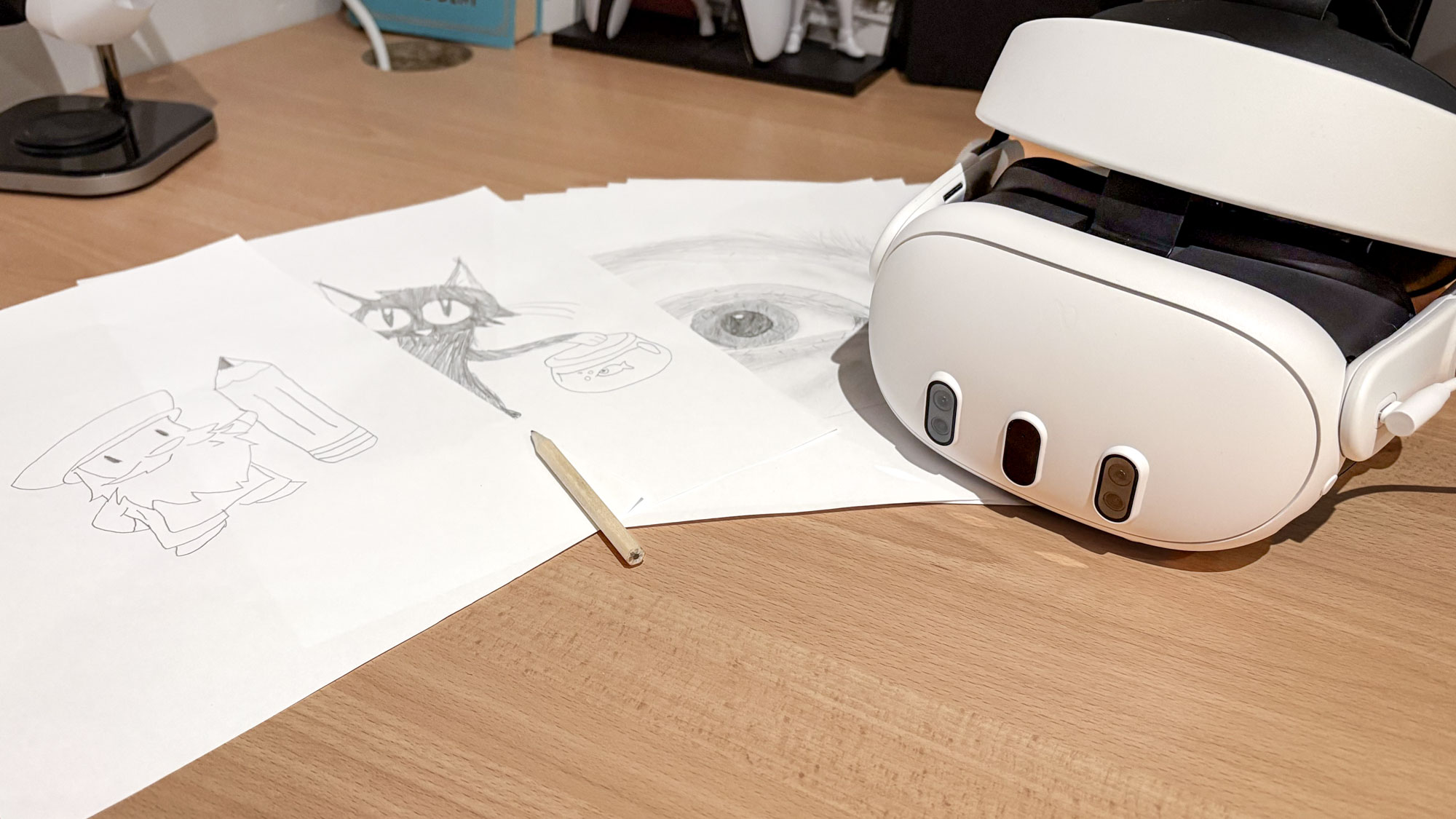 Meta Quest 3 on desk with drawings on paper on table with pencil on top