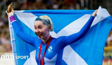 Katie Archibald holds up a Scotland flag