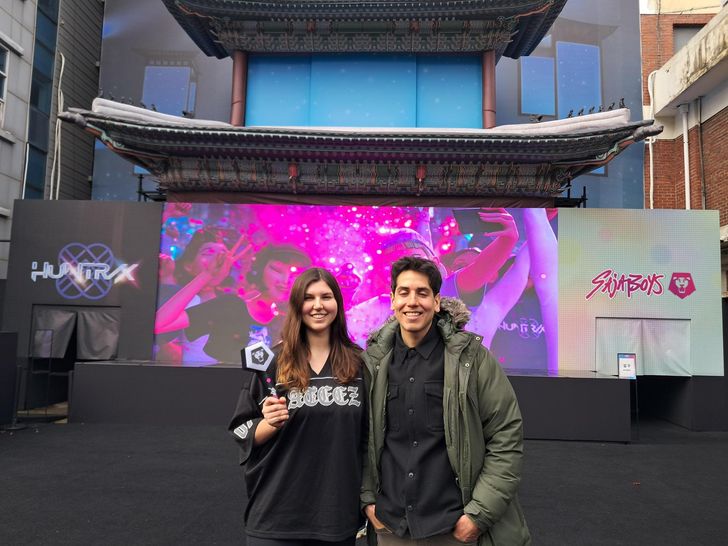 Carla Nicholson, left, from the U.S. and her colleague Gonzalo Albornoz from Canada stand outside the pop-up store venue in Seoul, Thursday. She is holding a Saja Boys light stick she purchased from the pop-up store. Korea Times photo by Kim Se-jeong 