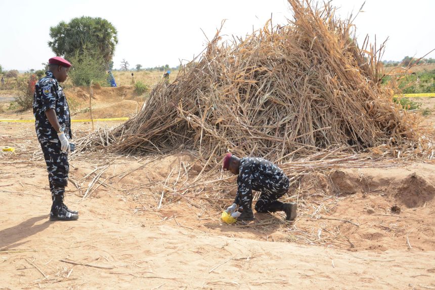 A Nigerian police bomb squad inspects the site of the airstrike in Jabo.