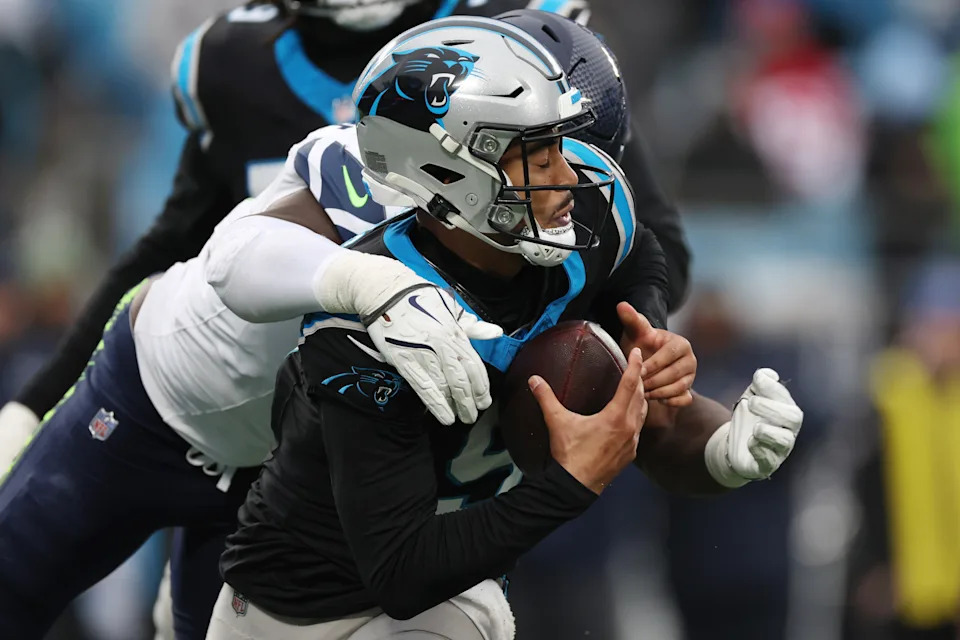 CHARLOTTE, NORTH CAROLINA - DECEMBER 28: Bryce Young #9 of the Carolina Panthers is sacked by Demarcus Lawrence #0 of the Seattle Seahawks during the fourth quarter at Bank of America Stadium on December 28, 2025 in Charlotte, North Carolina. (Photo by David Jensen/Getty Images)