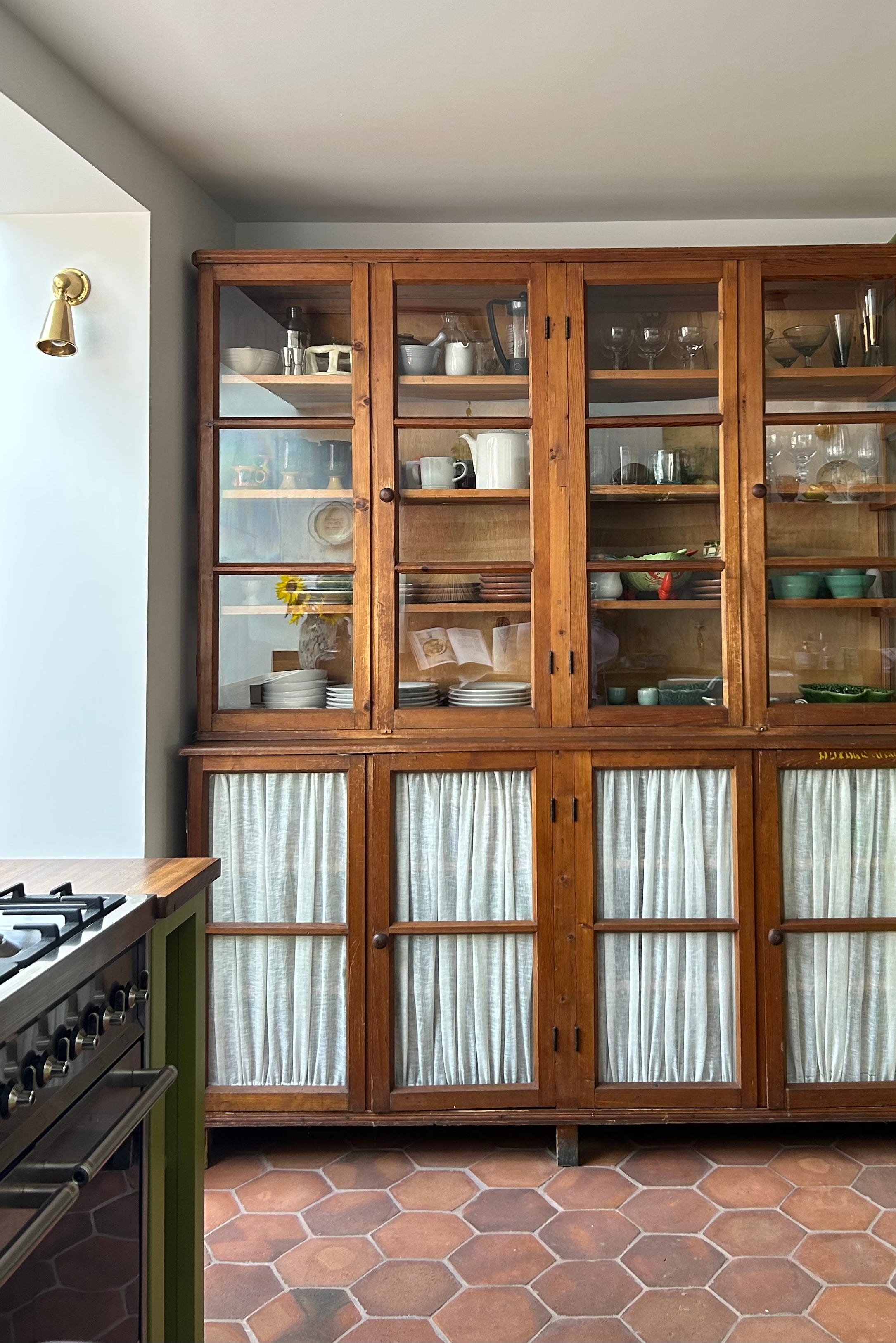 wooden cabinet displaying various dishes and glassware