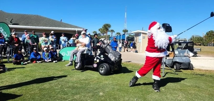 Santa Claus hits the ceremonial tee shot at the Jacksonville Beach Golf Club on Dec. 20 in the Jacksonville Area Golf Association Family Championship. At center is World Golf Hall of Fame member Dennis Walters, who conducted an exhibition between the morning and afternoon waves of the tournament.